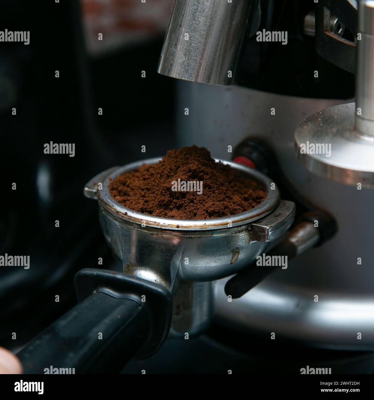 Professional barista working with a coffee machine and preparing hot drinks with coffee and milk. Stock Photo