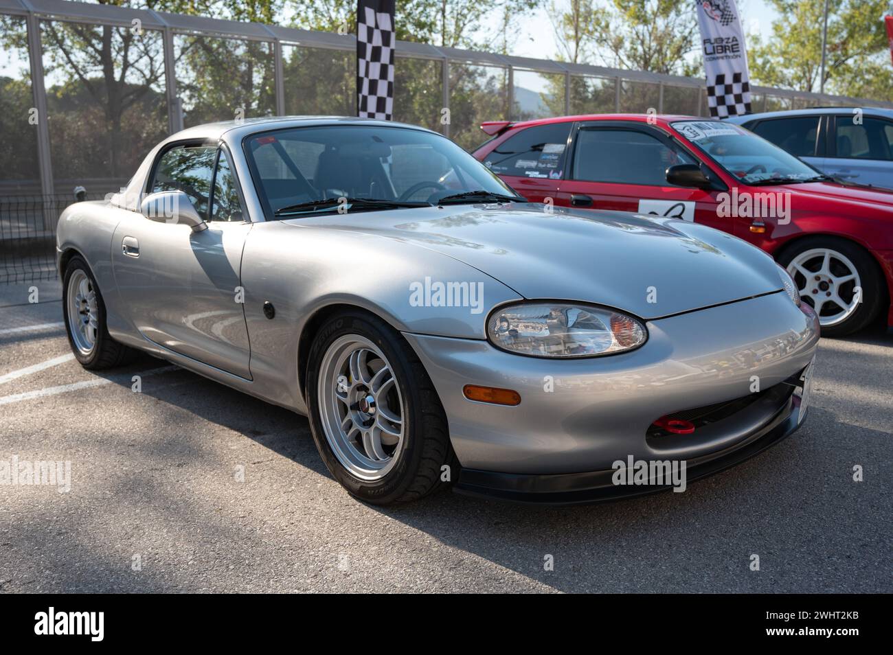 Front view of a nice gray Japanese light sports car, the Mazda Miata MX-5 NB, parked in the street. Stock Photo