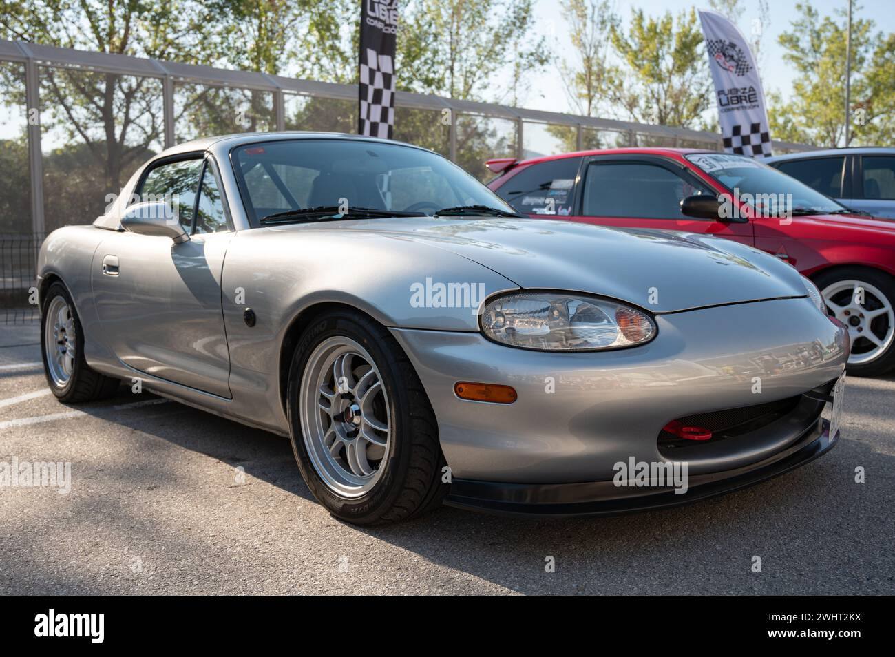 Front view of a nice gray Japanese light sports car, the Mazda Miata MX-5 NB, parked in the street. Stock Photo
