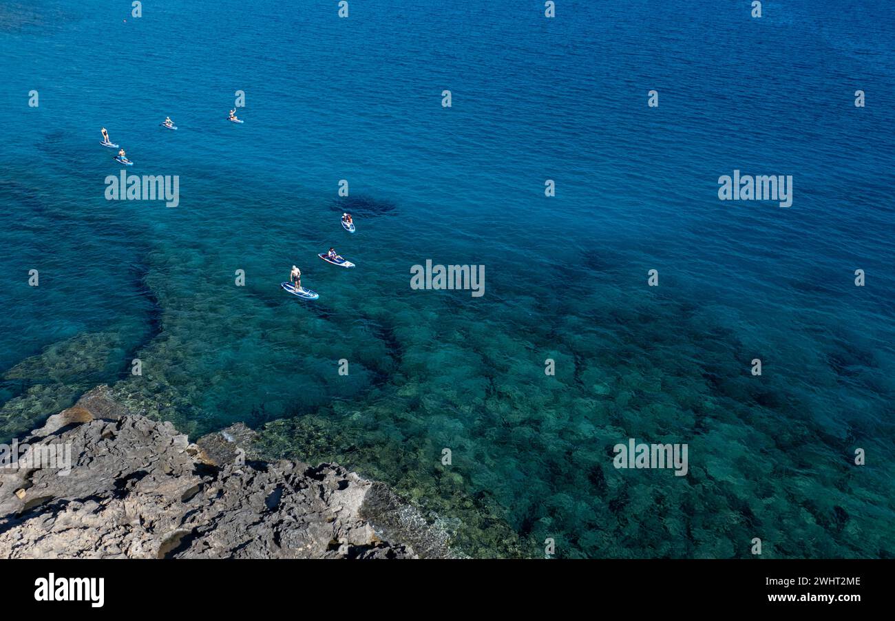 Done view of unrecognized people kayaking in the sea. People active, healthy lifestyle Stock Photo
