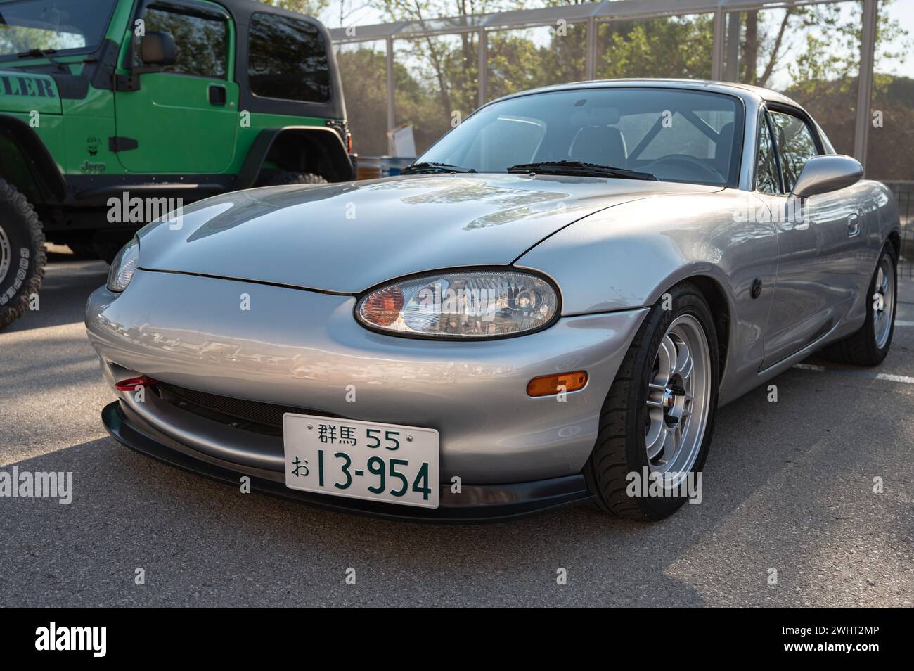 Front view of a nice gray Japanese light sports car, the Mazda Miata MX-5 NB, parked in the street. Stock Photo