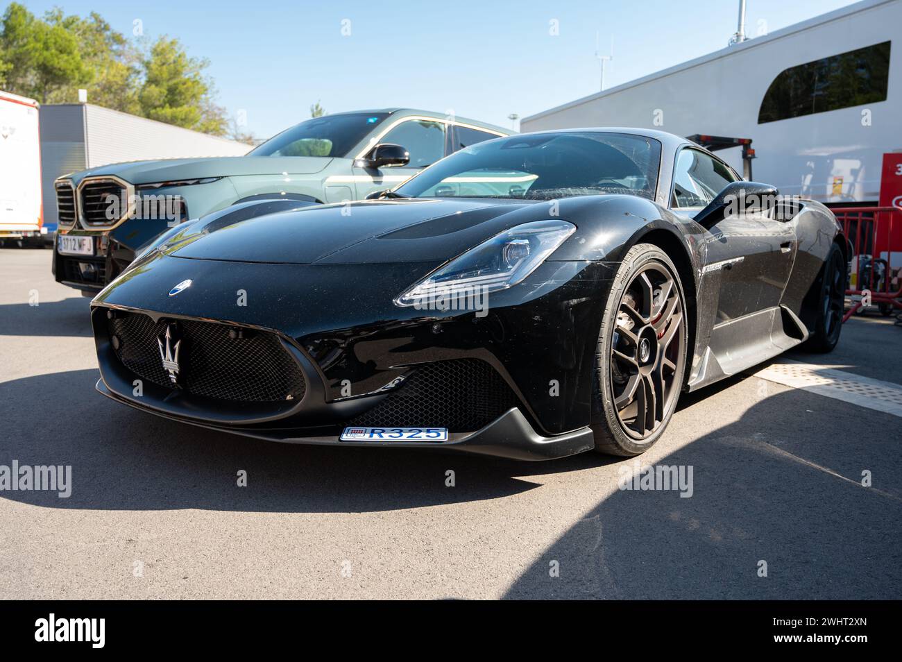 Front view of an impressive and exclusive black Maserati MC20 Italian sports car, it is a little dusty Stock Photo