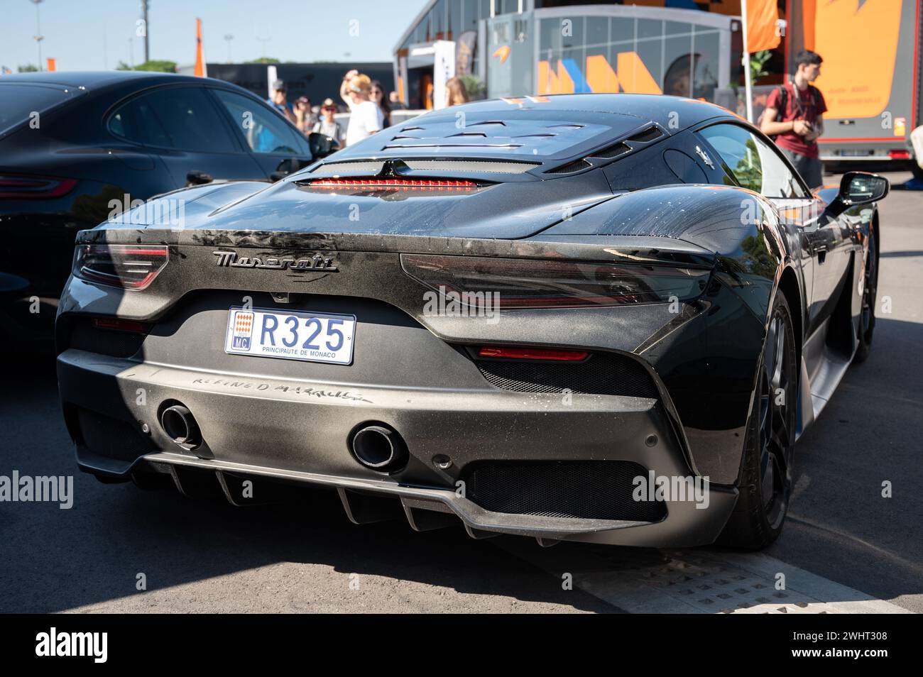 Rear view of an impressive and exclusive black Italian Maserati MC20 sports car, it is a little dusty Stock Photo