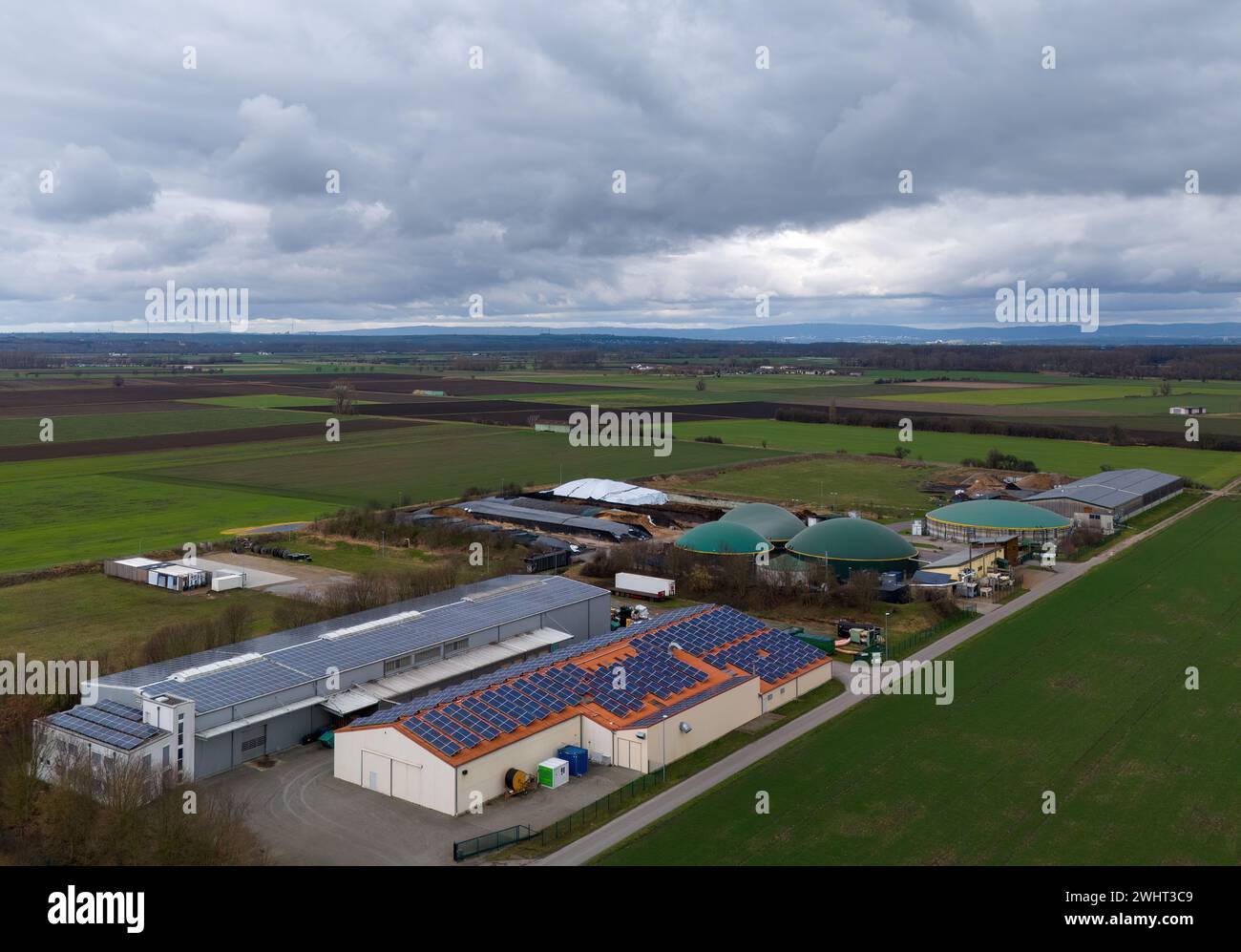 Biogas plant with solar cells in Hesse with Taunus in the background Stock Photo