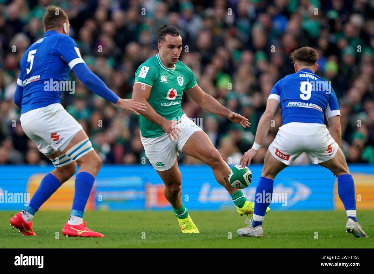 Ireland's James Lowe (centre) kicks the ball between Italy's Federico Ruzza (left) and Stephen Varney (right) during the Guinness Six Nations match at the Aviva Stadium in Dublin, Ireland. Picture date: Sunday February 11, 2024. Stock Photo