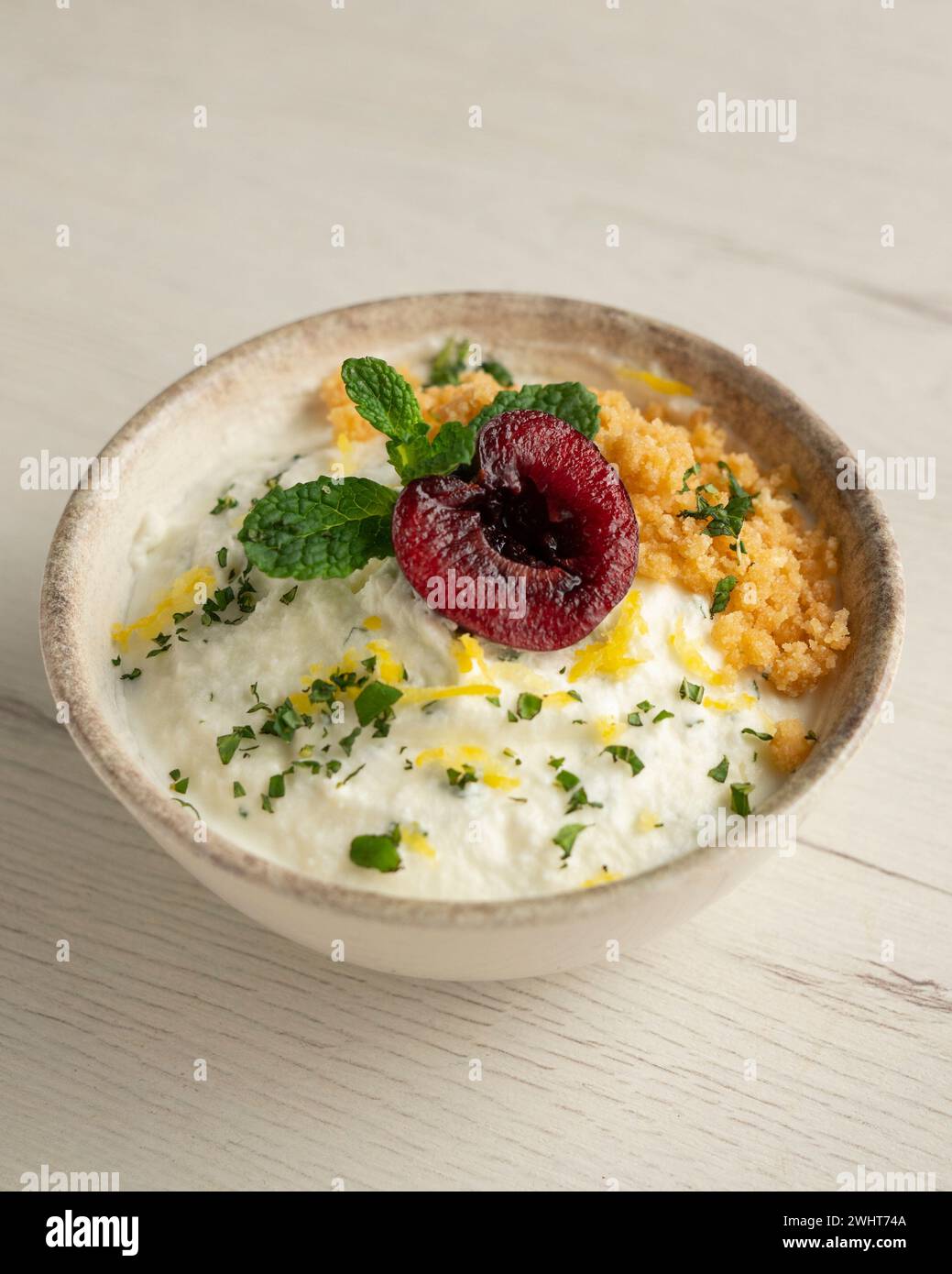 Yogurt and lemon mousse with cherries Stock Photo - Alamy