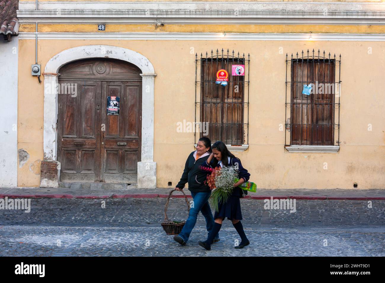 Antigua, Guatemala.  Street Scene, Two Women walking. Stock Photo