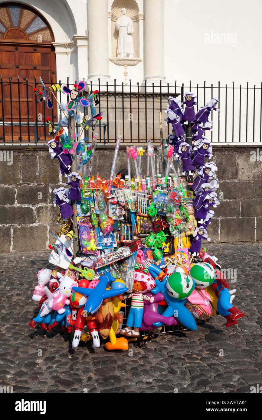 Antigua, Guatemala.  Vendor's Stand of Toys, Balloons, Cucurucho Dolls.  Semana Santa. Stock Photo