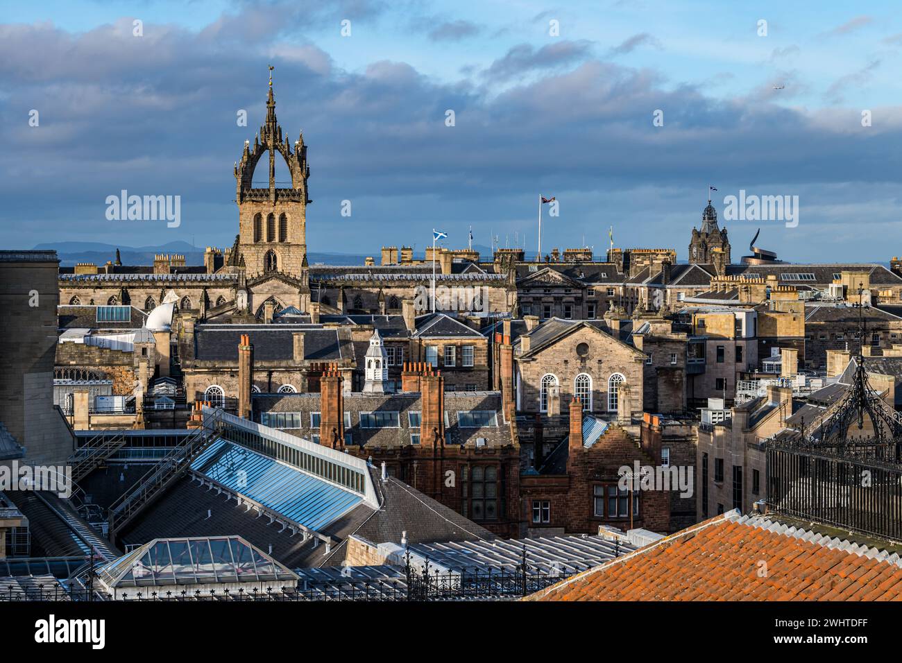 View over rooftops of St Gile's Church spire with Edinburgh city skyline, Scotland, UK Stock Photo