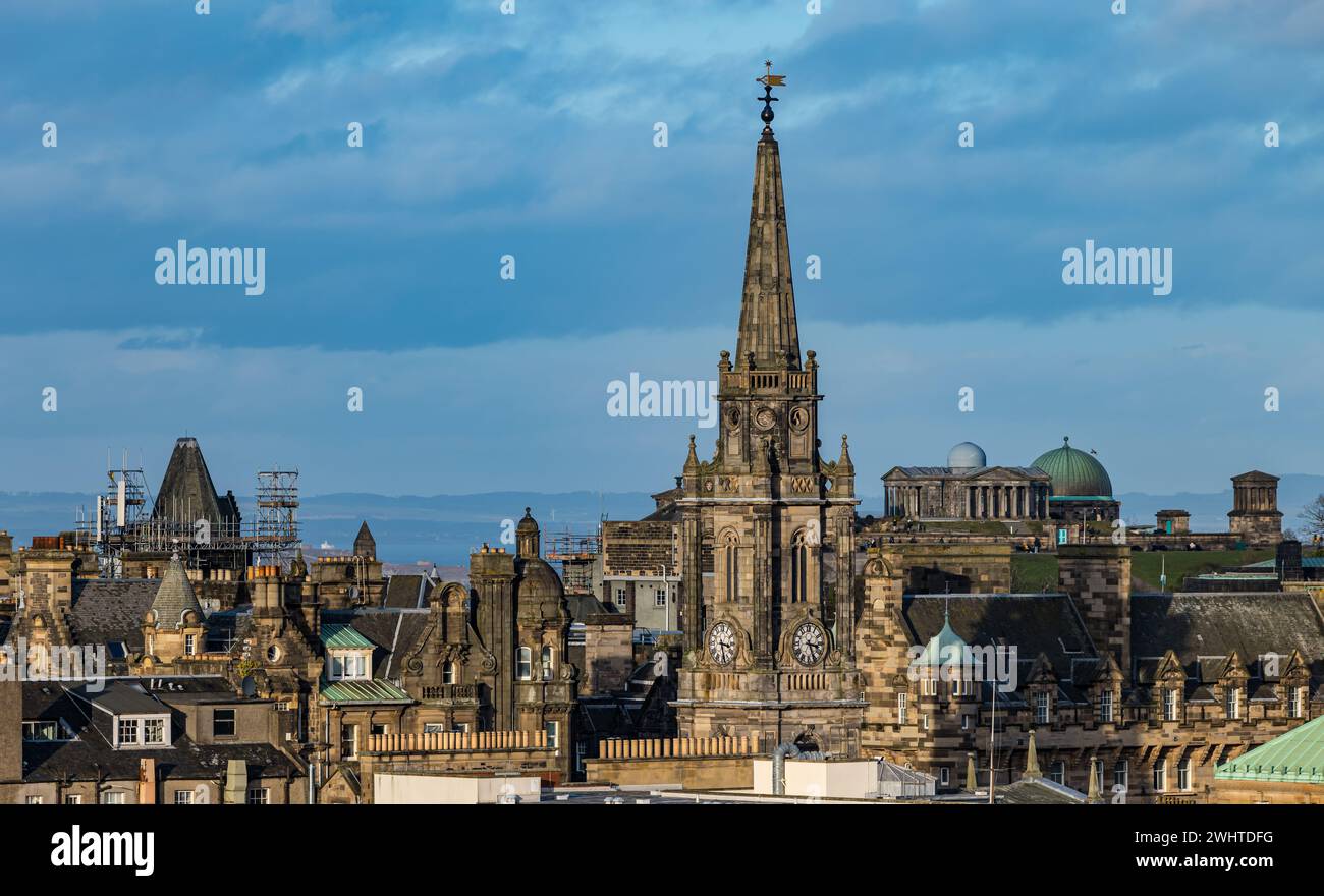 View over rooftops of Edinburgh city skyline with St Augustine's church spire and Calton Hill observatory, Scotland, UK Stock Photo