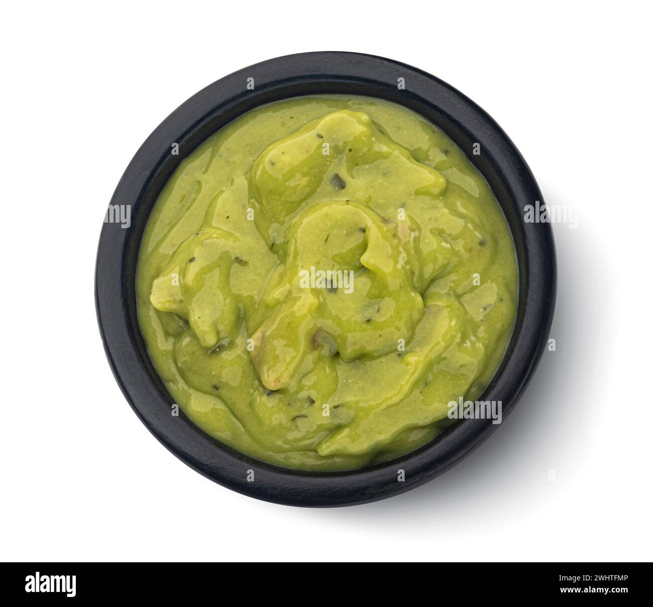 Bowl with guacamole isolated on white background, top view Stock Photo