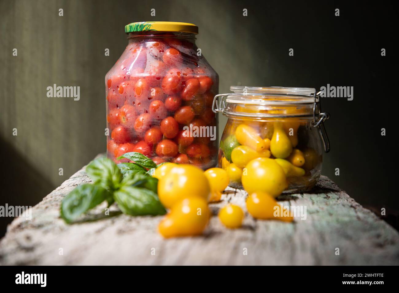 red and yellow cherry tomatoes in a jar for winter Stock Photo - Alamy