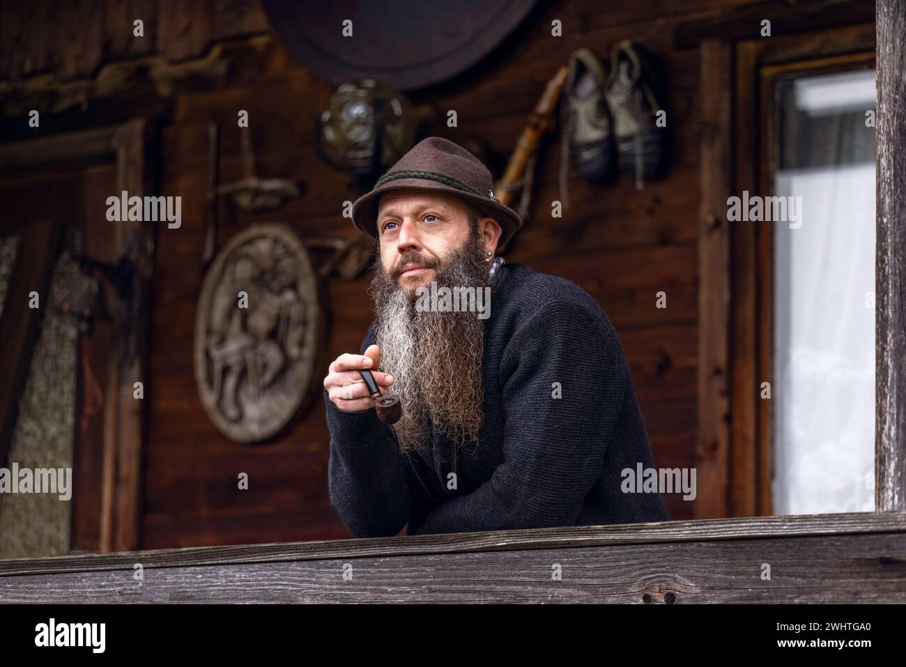 Portrait of a typical bavarian man smoking a pipe and wearing a