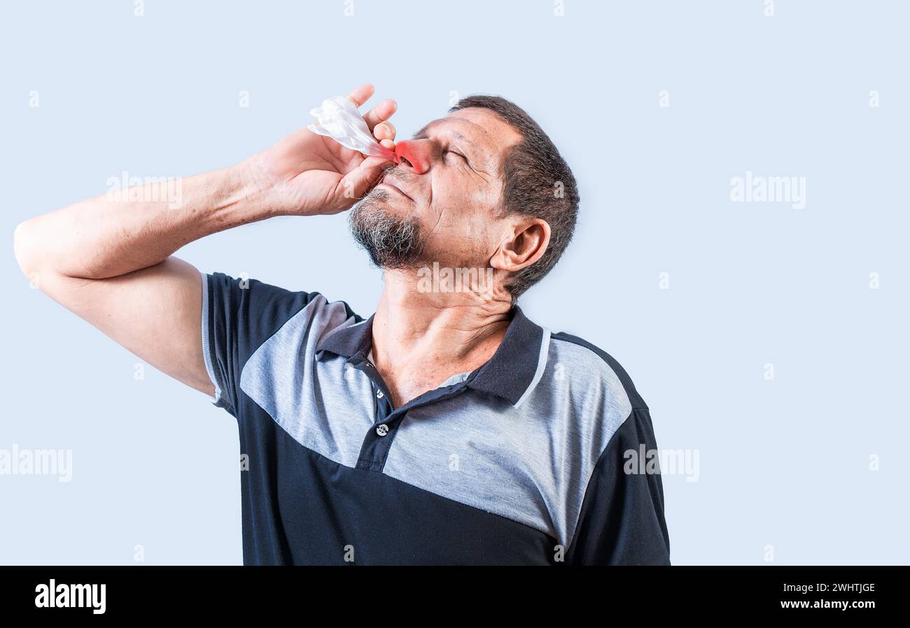 Person with nasal congestion, Senior man with irritated nose isolated. man with red nose cold, concept of sinusitis Stock Photo