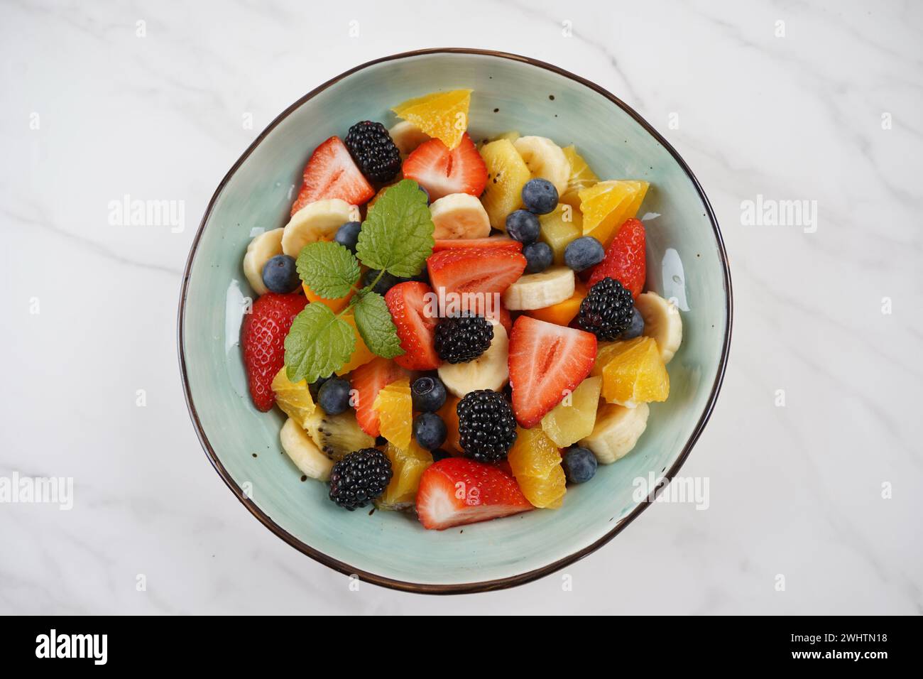 Summer Fruit salad with oranges, strawberries, blueberries, blackberries and fresh mint. Healthy food Stock Photo