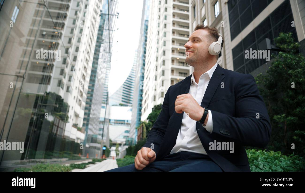 Low angle camera of project manager listening relaxing music while move ...