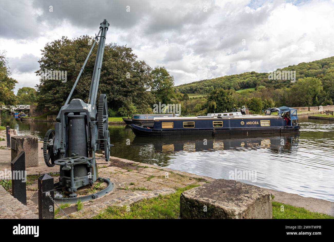 Grade II listed iron boat crane Narrowboat on the Kennet and Avon canal at the Dundas Aqueduct / Wharf, Somerset, England, UK Stock Photo