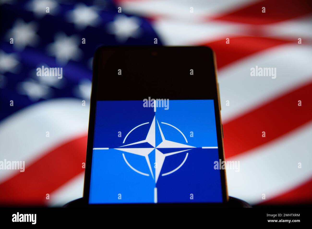 U.S.A and NATO Illustrations. NATO logo and the United States of America flag are displayed on screens on February 11, 2024 in Warsaw, Poland. Warsaw Poland Copyright: xAleksanderxKalkax Stock Photo
