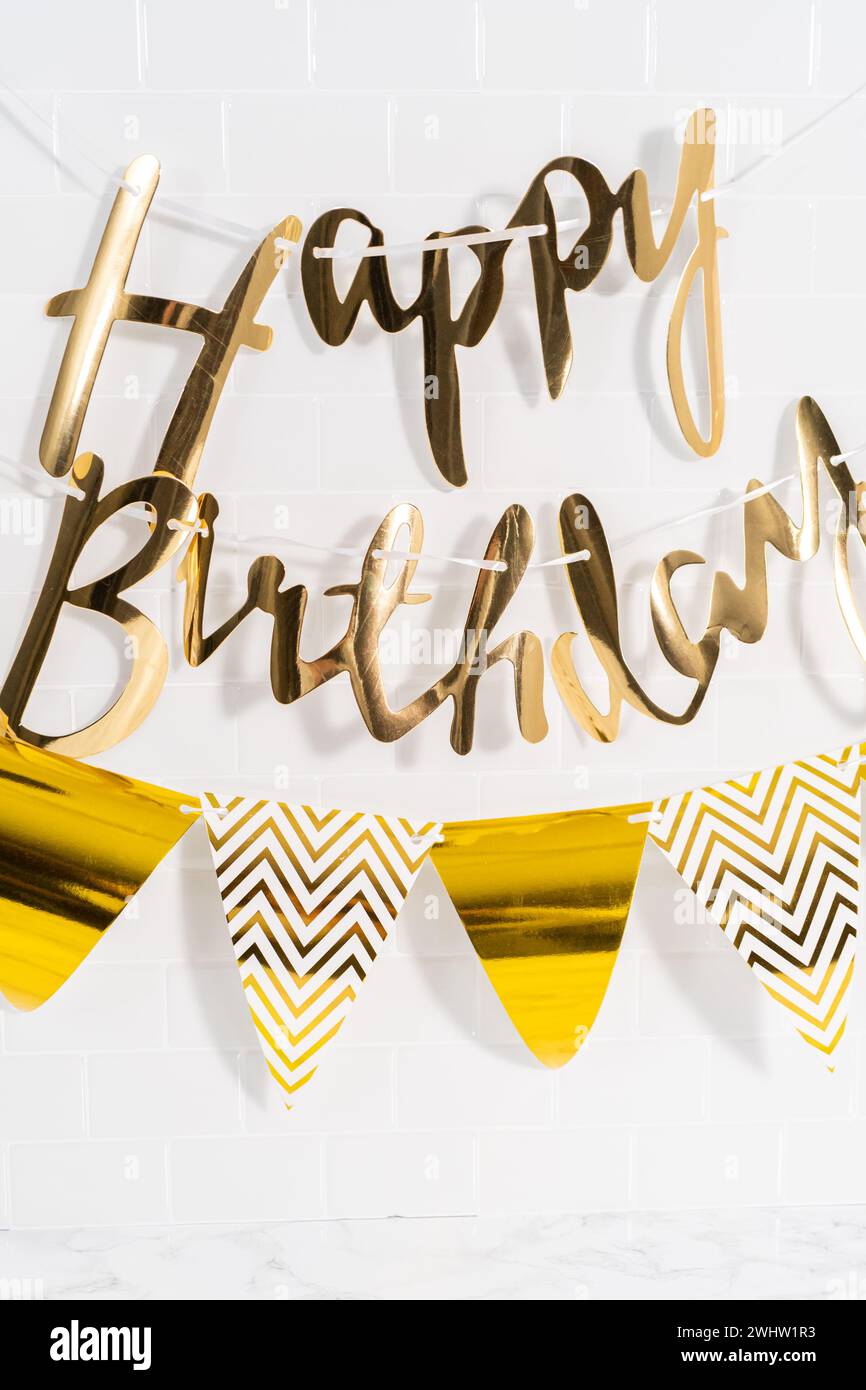 Paper Happy Birthday gold paper banner in the kitchen Stock Photo - Alamy