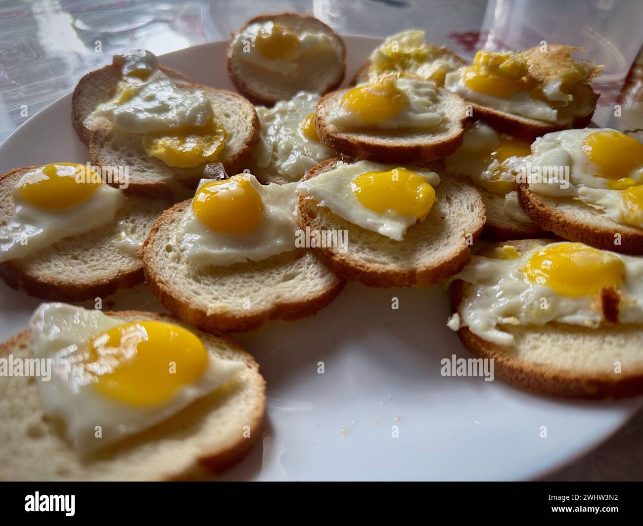Homemade Mini Sunny-Side-Up Eggs on Toast: A Delightful Breakfast Presentation Stock Photo