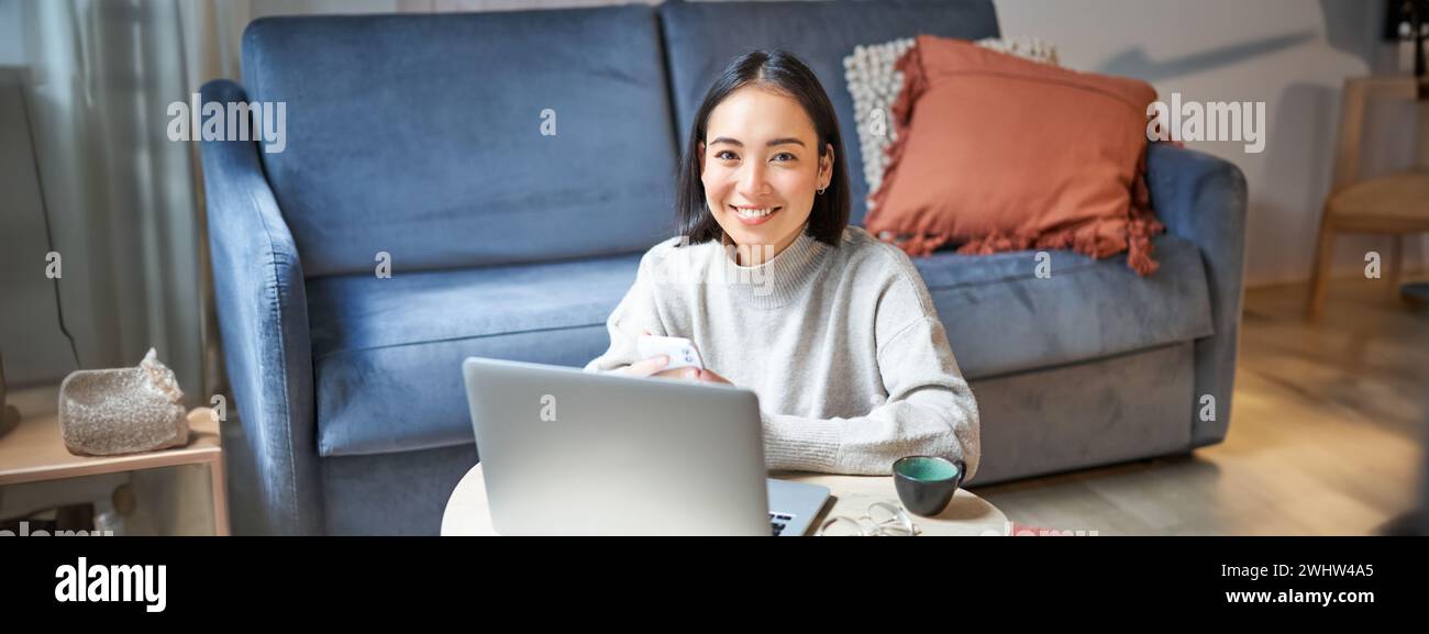 Work from home, freelance and e-learning concept. Young woman studying, sitting in front of laptop, working on remote, worplace Stock Photo