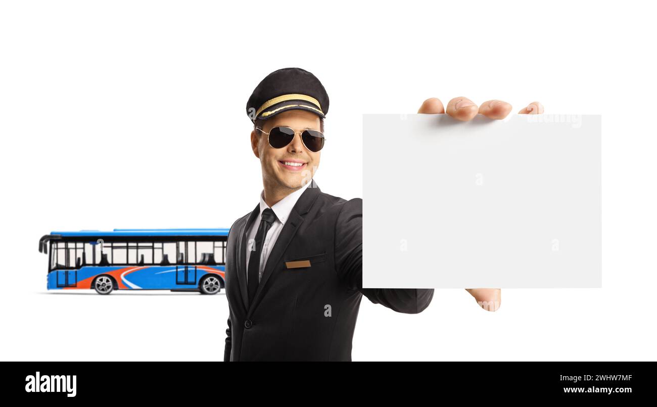 Chauffeur in a uniform holding a blank card in front of a city bus isolated on white background Stock Photo
