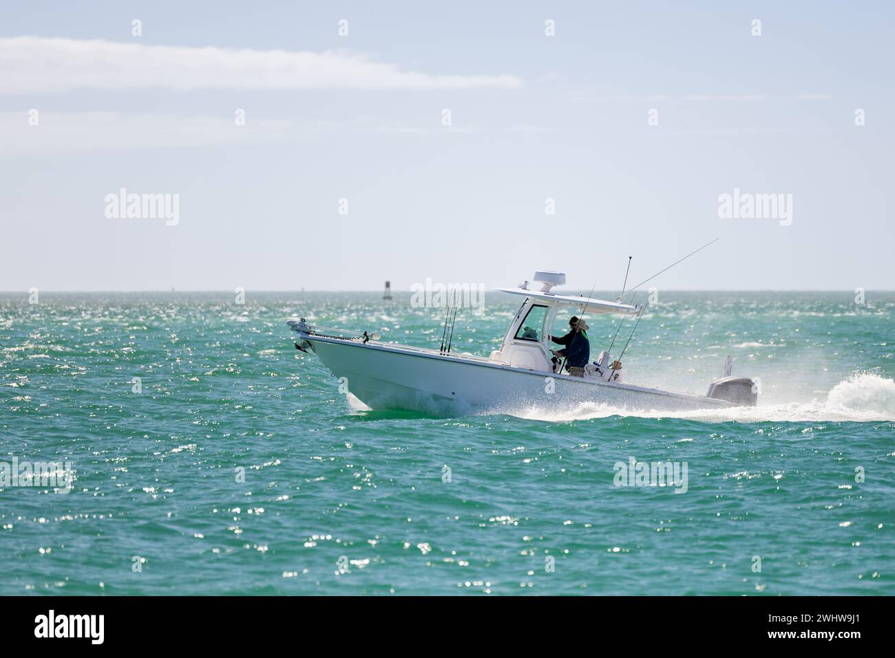 Saltwater fishing boat on a sunny summer day. People on recreational power boat cruising the Gulf of Mexico, Florida. Stock Photo