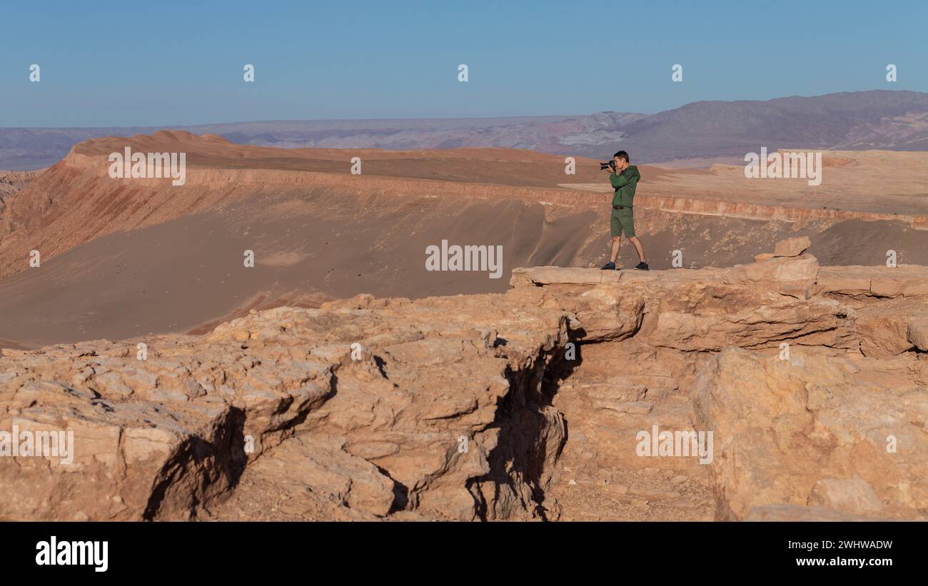 A single man at a viewpoint of the Valle de la Luna, Valley of the Moon, in the Atacama Desert, which resembles the surface of the moon. Stock Photo