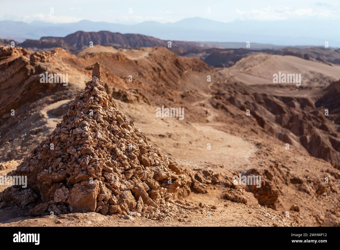 A red pile of stones in front of the hiking trail that runs through the Valley of Death, Valle de la Muerte, in the Atacama Desert. Stock Photo