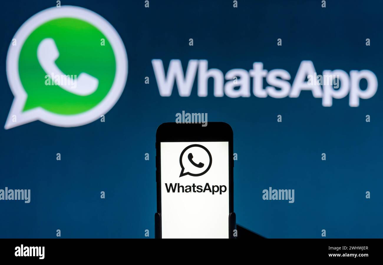 India. 12th Feb, 2024. In this photo illustration, the WhatsApp logo is seen displayed on a mobile phone screen and in the background. Credit: SOPA Images Limited/Alamy Live News Stock Photo