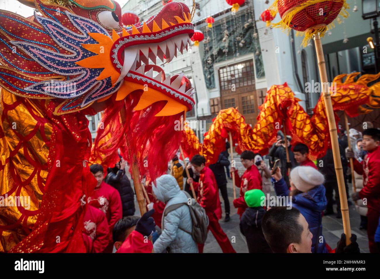 Moscow, Russia. 10th of February, 2024. Artists perform a dragon dance during the Chinese Lunar New Year celebration at a street as part of the Chinese New Year Festival in Moscow in Kamergersky Lane, Russia Stock Photo