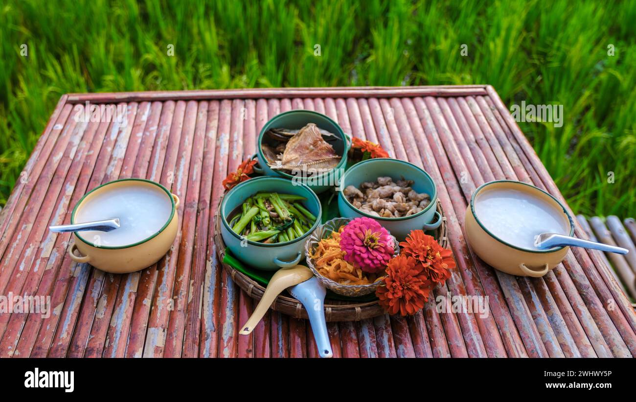 Thai breakfast with a green rice paddy field during sunrise Stock Photo ...