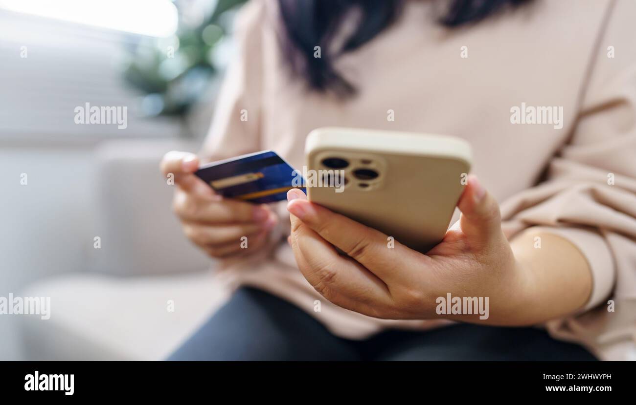 Senior woman with smart phone for online shopping.  Hand holding mobile phone with Payment on credit card online shopping electr Stock Photo