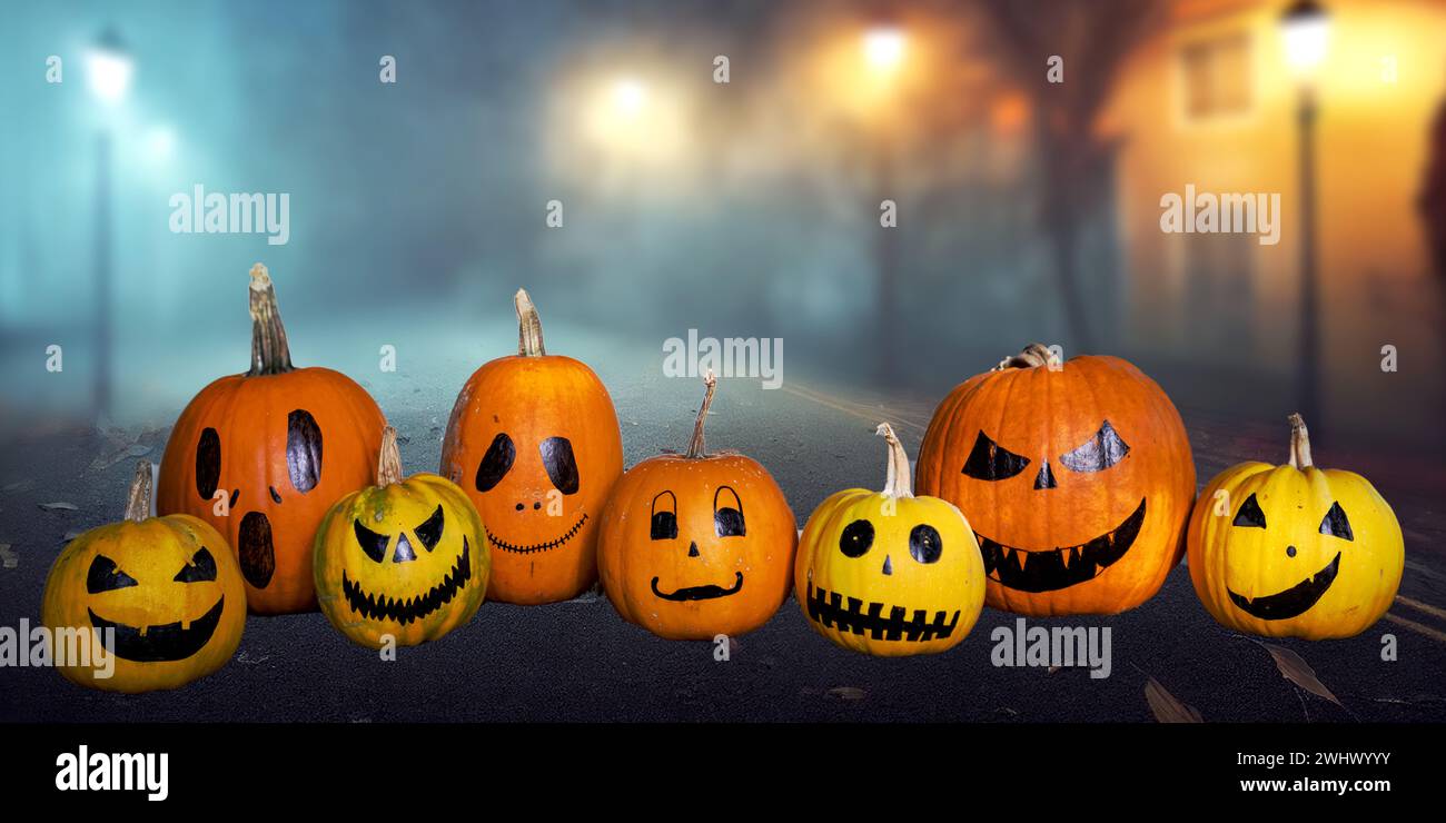 Scary funny Halloween pumpkins on wooden table Stock Photo