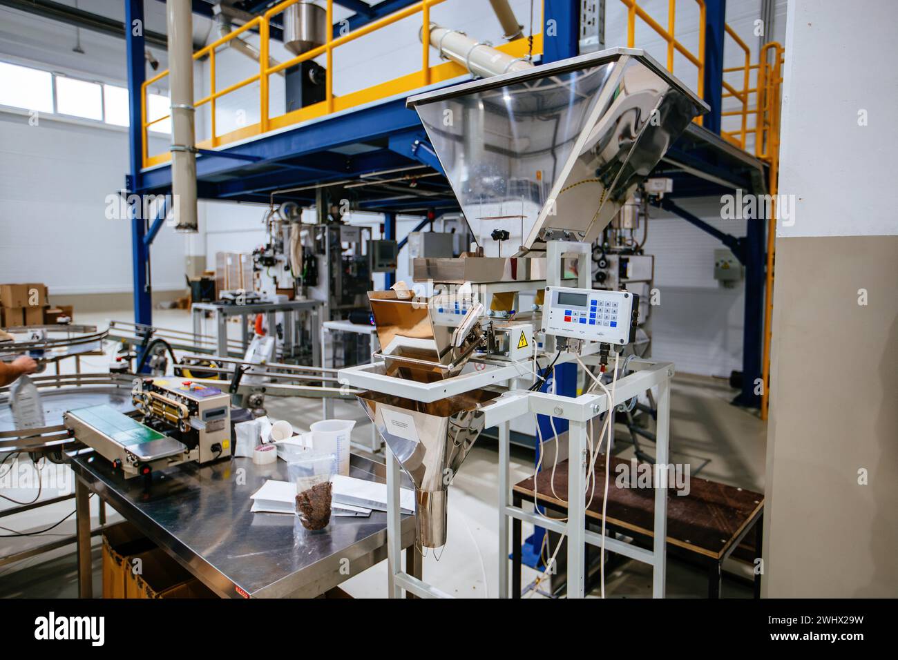 Modern industrial coffee packaging machine. Stock Photo