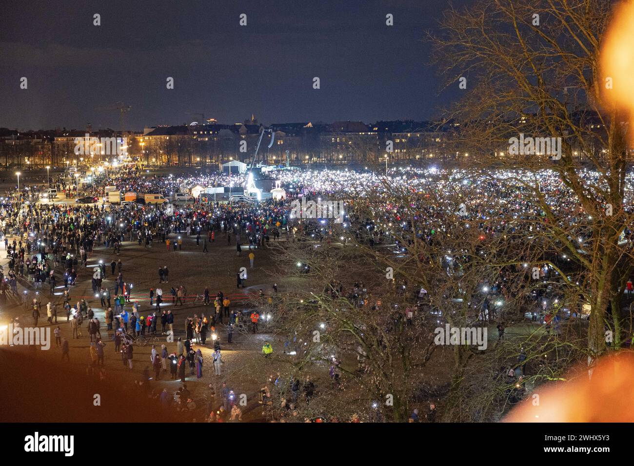 Munich, Germany. 11th Feb, 2024. Hundreds of thousands gathered on the Theresienwiese in Munich, Germany on February 11, 2024 for a so-called sea of lights against right-wing extremism, racism and the AfD. Participants illuminated the square in front of the Bavaria with flashlights, cell phone lights and lamps. The protest was motivated by a Correctiv research published this week on meetings in the Landhaus Adlon where deportation plans were elaborated. (Photo by Alexander Pohl/Sipa USA) Credit: Sipa USA/Alamy Live News Stock Photo