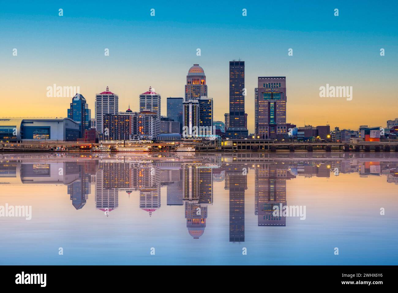Beautiful sunset night view of Louisville Kentucky Skyline with river and lit buildings Stock Photo