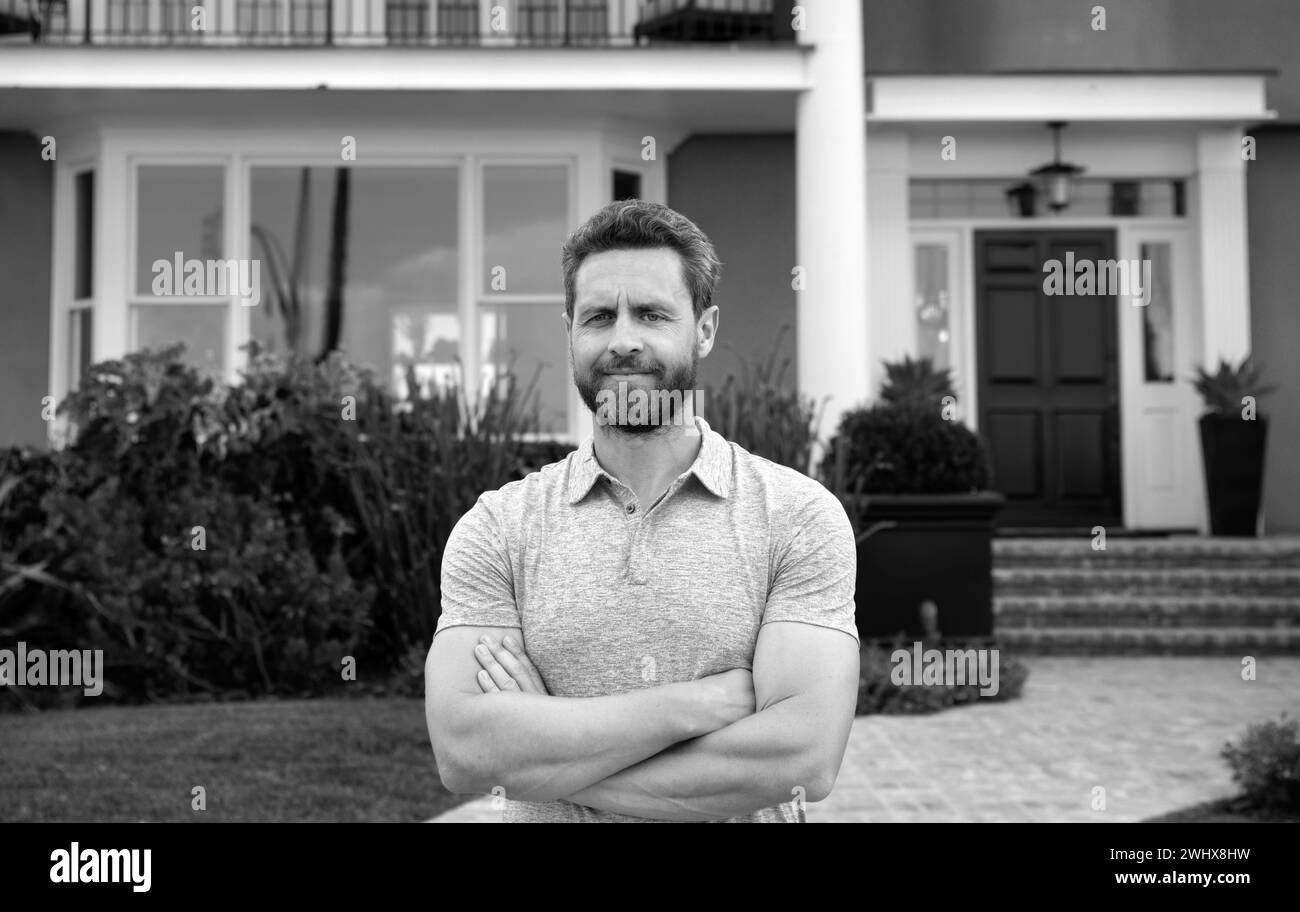 Portrait of a happy man standing outside house Stock Photo - Alamy