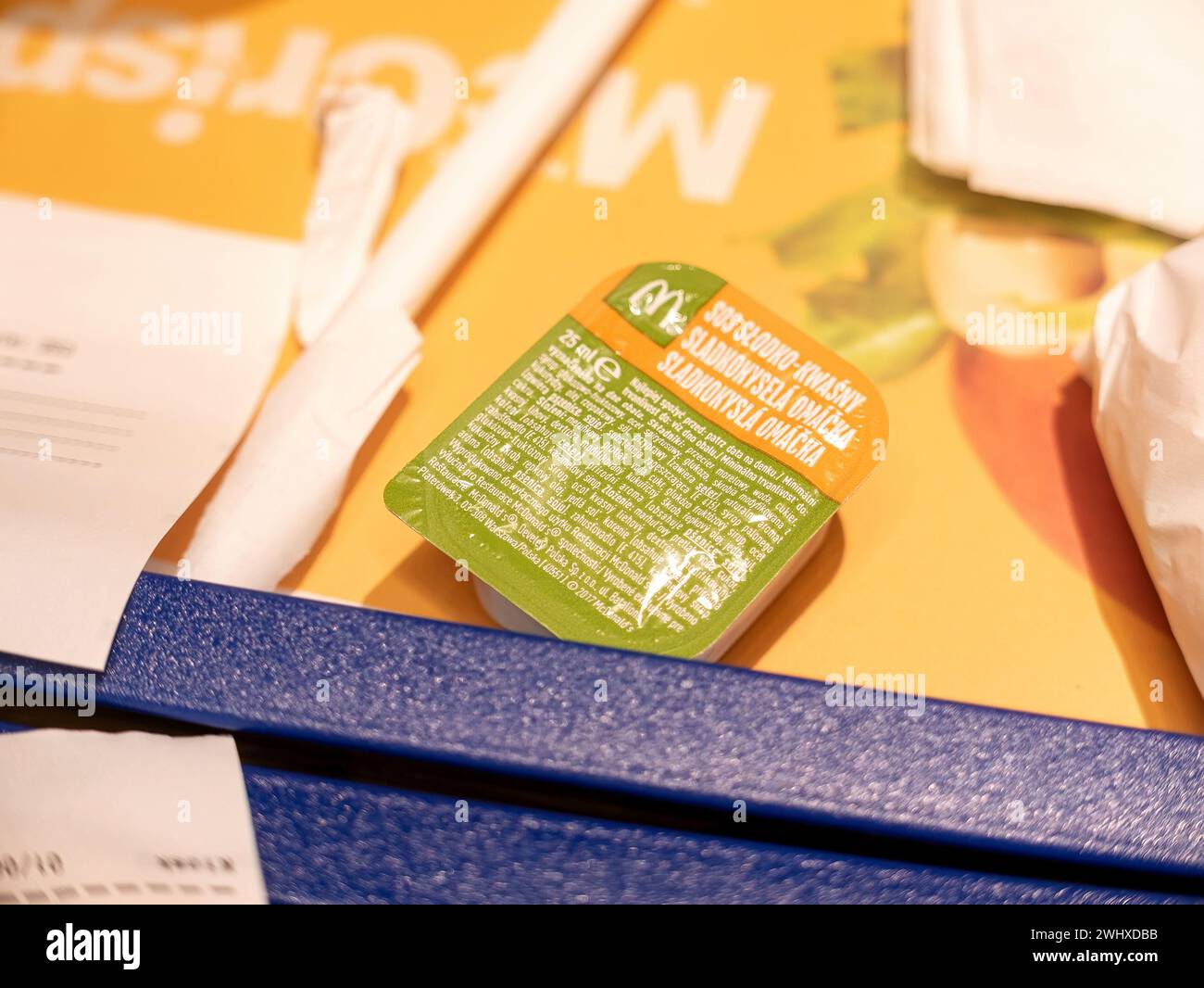 McDonalds sweet and sour sauce 25ml container object macro extreme closeup detail, nobody