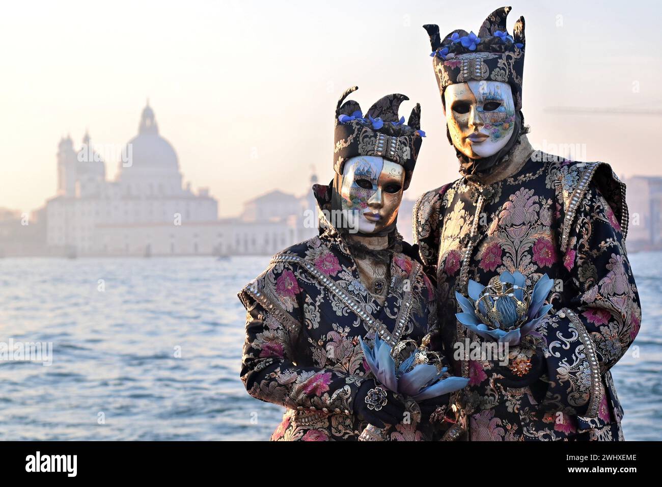 Venice, Italy. 03rd Feb, 2024. Revelers pose with beautiful masks ...