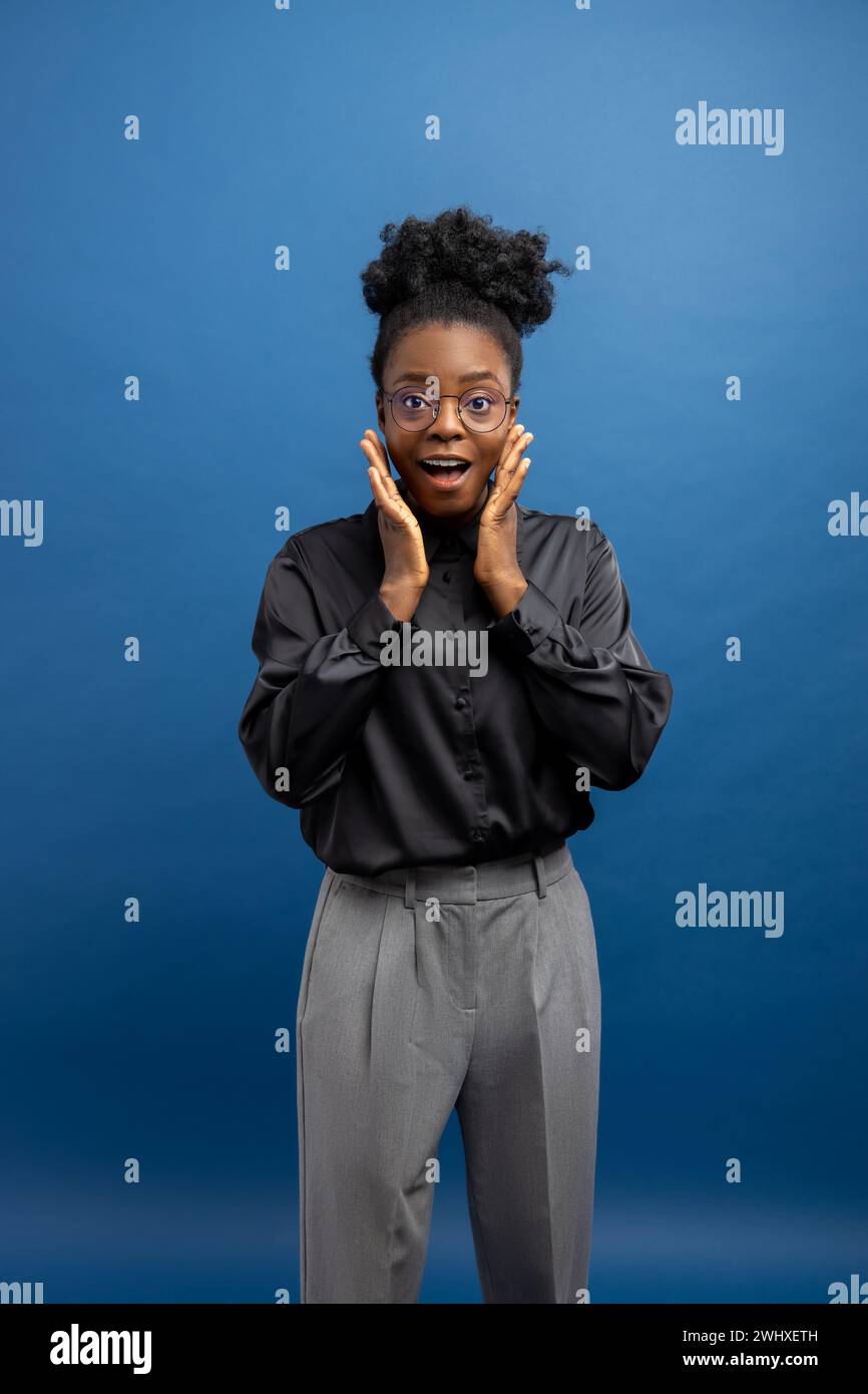 Elegant smiling dark-skinned woman touching her head Stock Photo - Alamy