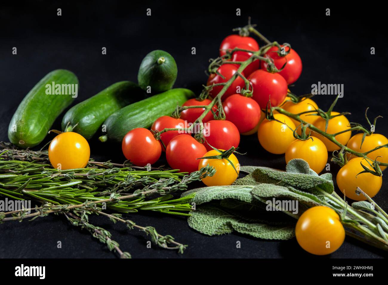 Fresh vegetables and herbs on black background Stock Photo