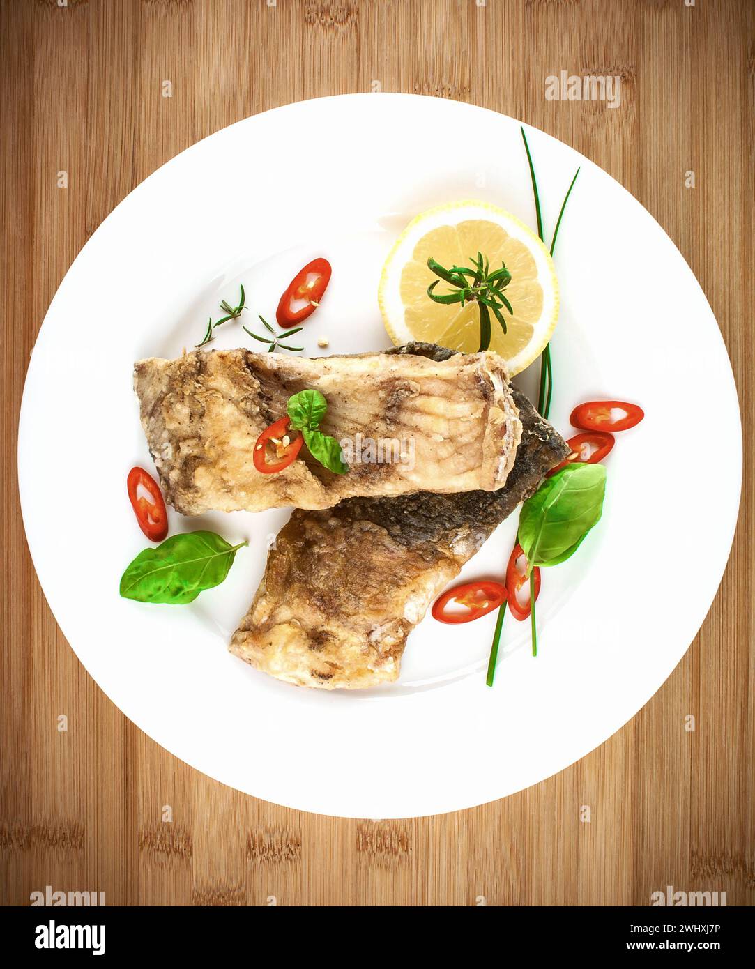 Fried fish on white plate, top view Stock Photo