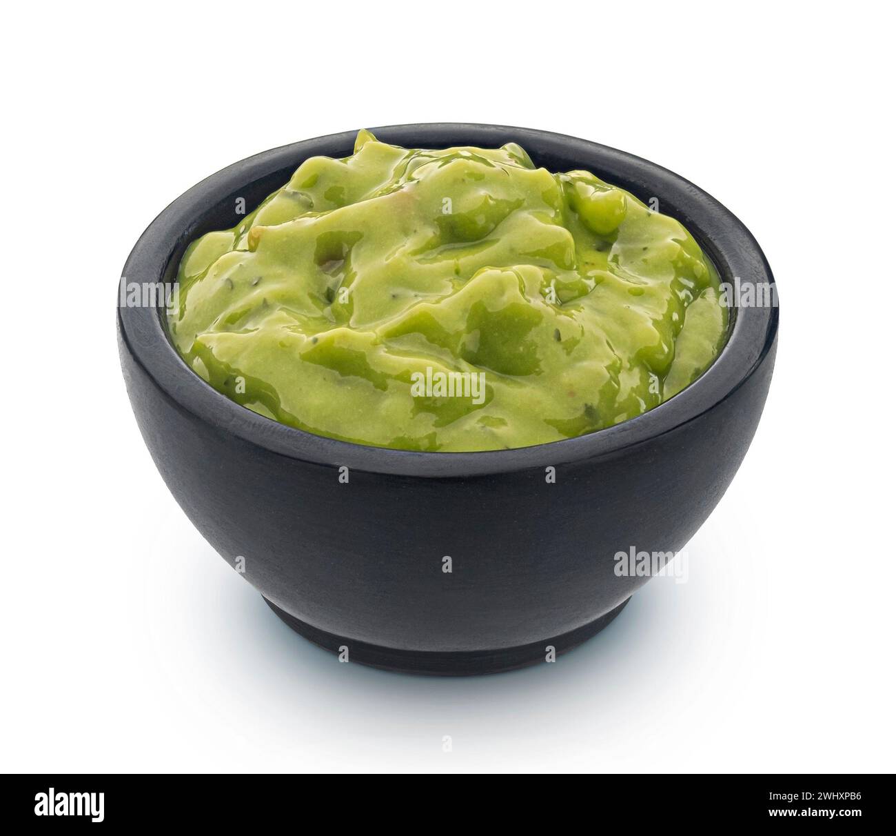 Bowl with guacamole isolated on white background Stock Photo