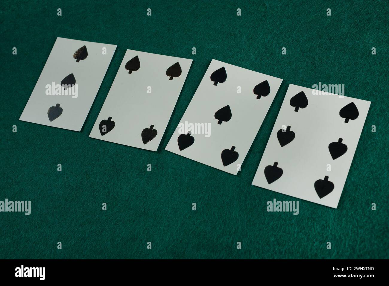 Old west era playing card on green gambling table. 3, 4, 5, 6 of spades. Stock Photo