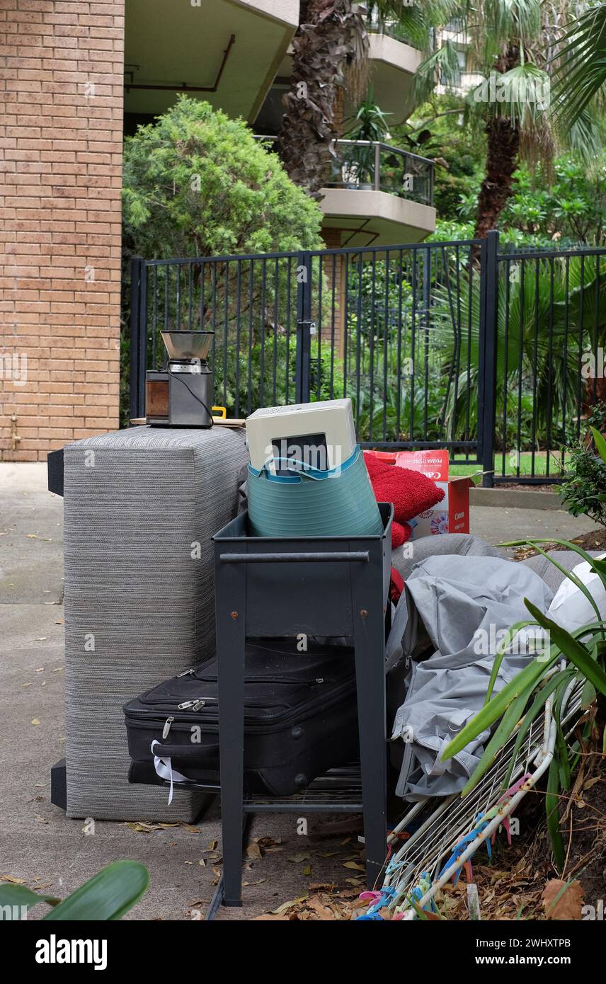 Illegal street dumping of household goods, kitchen appliances, furniture and personal goods. One of the signs of housing stress in the rental market Stock Photo