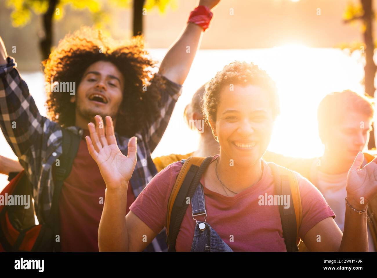 Millennial Friends Cheering at Sunset Stock Photo