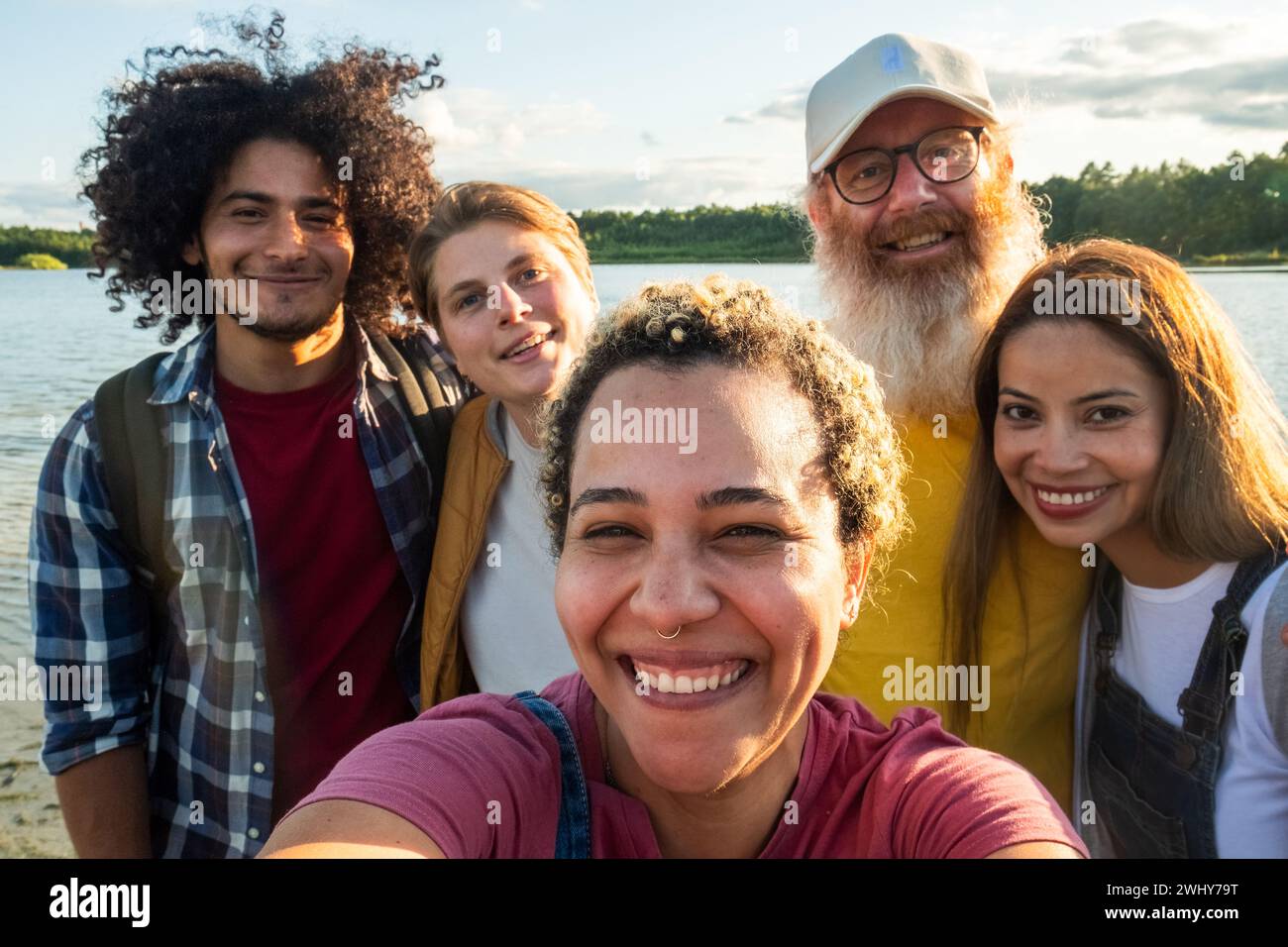 Diverse Friends Taking Selfie on Lake Beach Stock Photo
