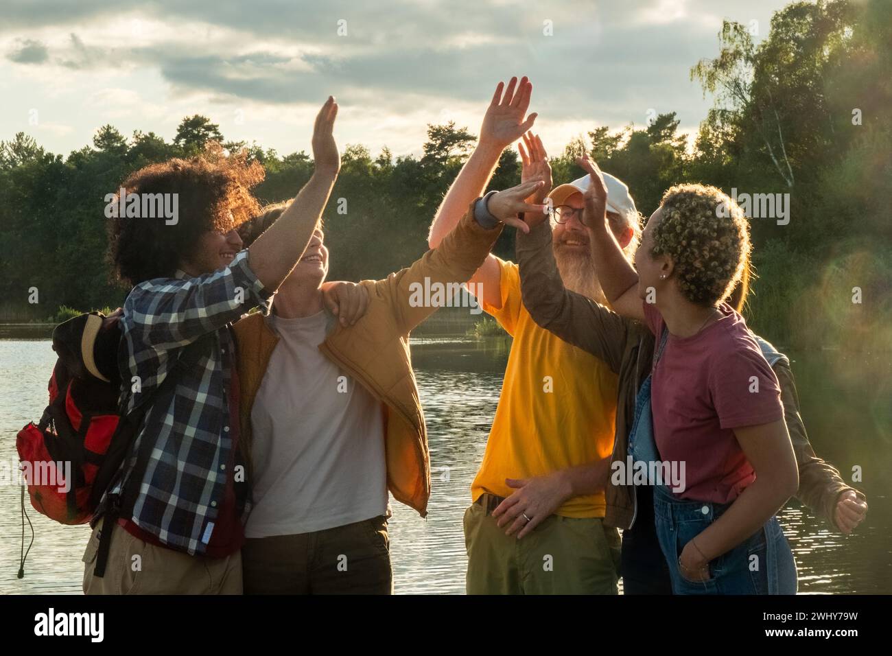 Millennial Friends High-Fiving on Hike Stock Photo
