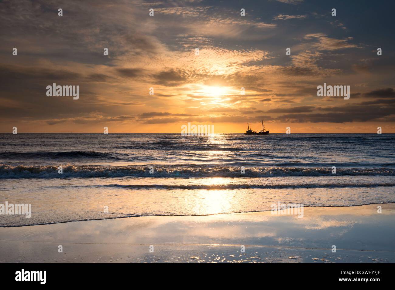 Ship on horizon in sea at sunset Stock Photo - Alamy